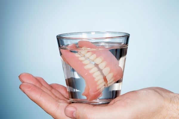 Ngâm hàm vào ly nước để hàm không bị co giãn