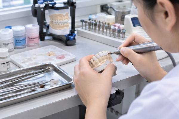 Kỹ thuật viên chế tác răng sứ trong phòng lab - Bọc răng sứ có hại không